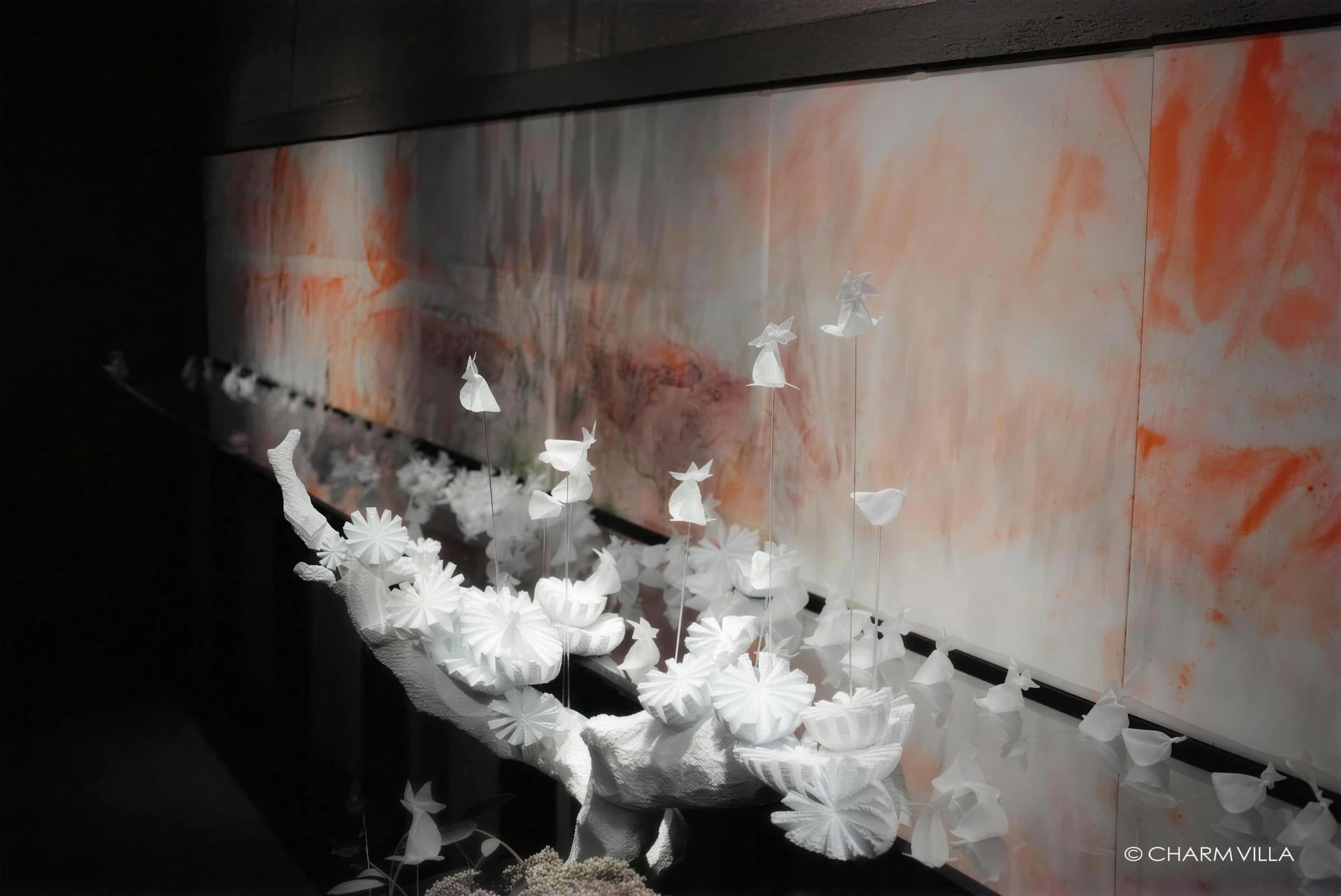 White paper goldfish and blossoms hanging in an exhibition