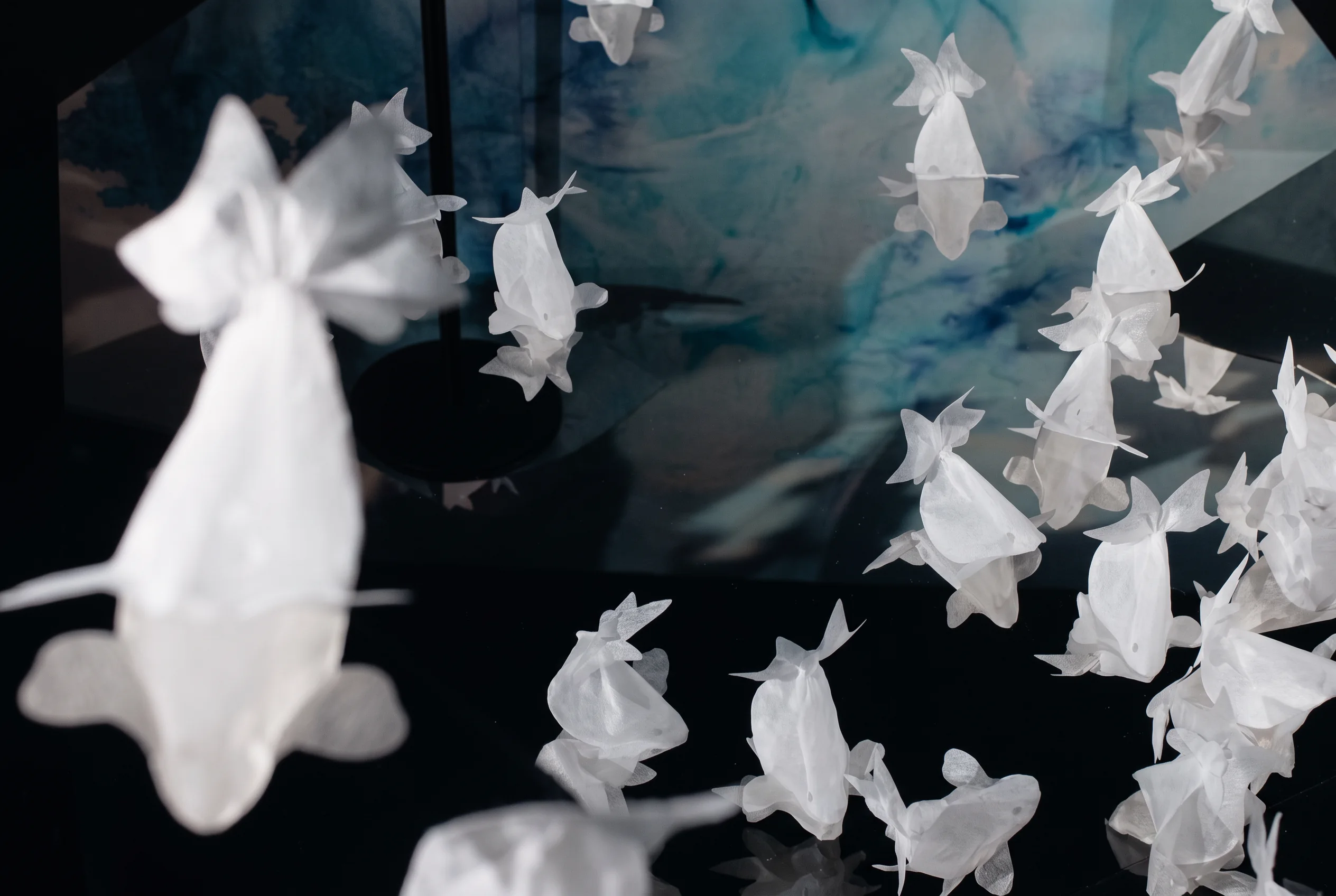 White paper goldfish hanging in an exhibition